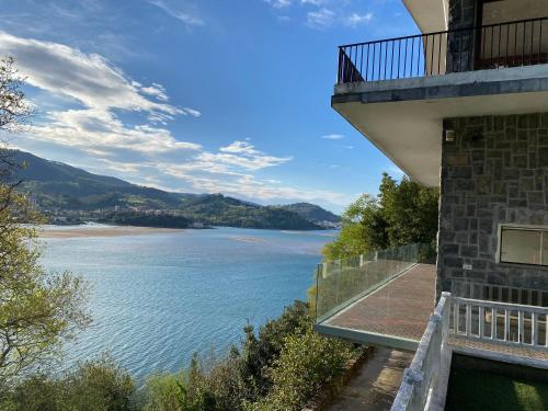 a building with a view of a body of water at Kizkitza in Gautegiz Arteaga