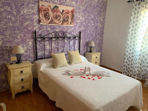 a bedroom with a bed with roses on it at Apartamento Muelle de Corralejo 14 in Corralejo
