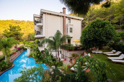 an exterior view of a house with a swimming pool at Esperanza Boutique Hotel of Lykia in Karaoz