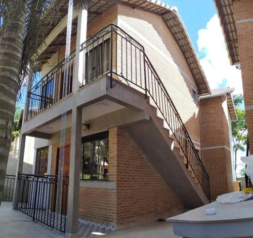 a building with a staircase on the side of it at Chalés Estrada Real in Conceição da Ibitipoca