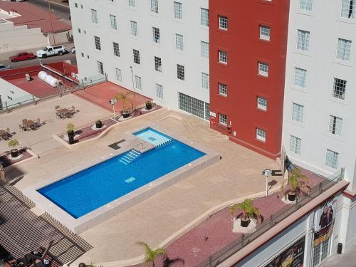 an overhead view of a swimming pool in front of a building at Fiesta Inn Ciudad Obregon in Ciudad Obregón