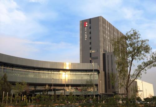 a building with a sign on the side of it at Fiesta Inn Parque Puebla in Puebla
