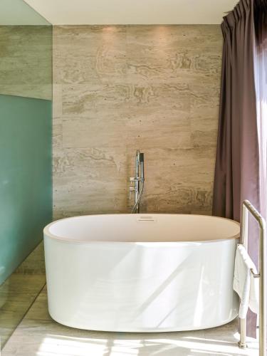 a white tub in a bathroom with a shower at Fiesta Americana Ciudad de México Satelite in Mexico City