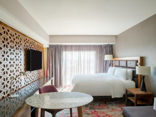 a hotel room with a bed and a large window at Fiesta Americana Ciudad de México Satelite in Mexico City