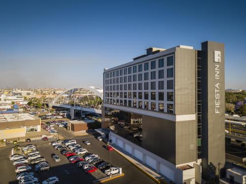 an aerial view of a building with a parking lot at Fiesta Inn Aguascalientes Patio in Aguascalientes