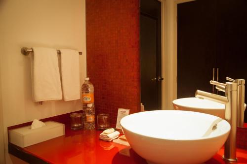 a bathroom with a white sink on a counter at Fiesta Inn Periferico Sur in Mexico City