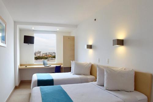 Cama o camas de una habitación en One Culiacan Forum