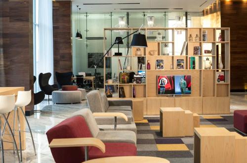 a lobby with chairs and tables in a store at Fiesta Inn Merida in Mérida