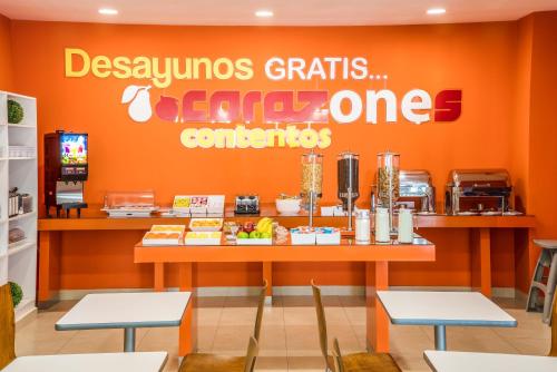 a fast food restaurant with an orange wall at One Mexicali in Mexicali