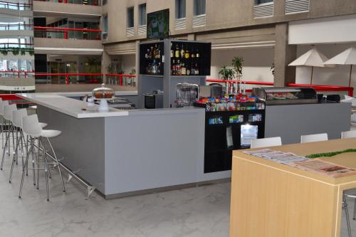a bar with stools and a counter in a building at Fiesta Inn Tlalnepantla in Mexico City