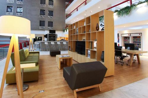 a living room with a couch and a table at Fiesta Inn Tlalnepantla in Mexico City