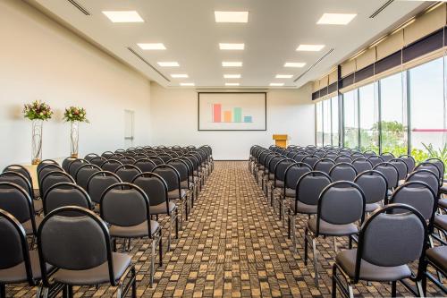 an empty room with rows of chairs in a classroom at Fiesta Inn Playa del Carmen in Playa del Carmen