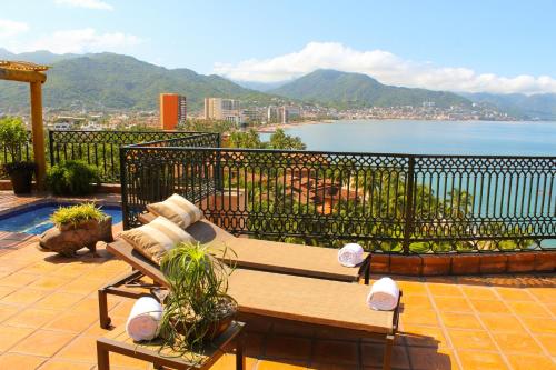 a bench on a balcony with a view of the water at Fiesta Americana Puerto Vallarta All Inclusive & Spa in Puerto Vallarta