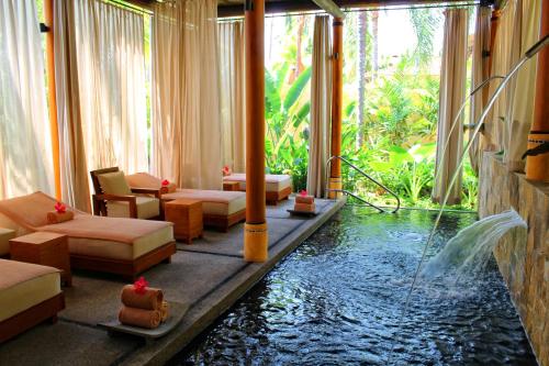 a hotel room with a pool of water in a room at Fiesta Americana Puerto Vallarta All Inclusive & Spa in Puerto Vallarta
