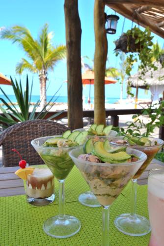 a table with three wine glasses filled with fruit at Fiesta Americana Puerto Vallarta All Inclusive & Spa in Puerto Vallarta