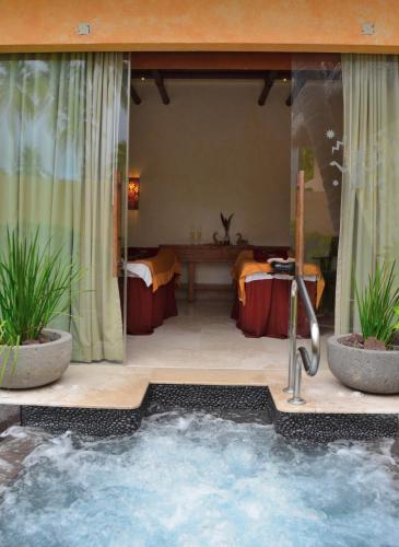 a jacuzzi tub in a room with a table at Fiesta Americana Puerto Vallarta All Inclusive & Spa in Puerto Vallarta