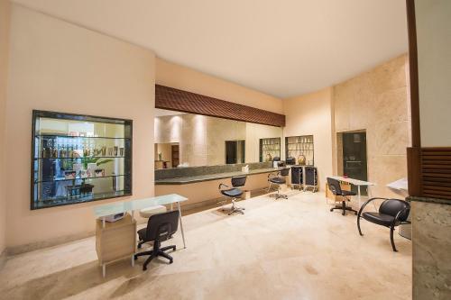 a room with chairs and tables and a bar at Fiesta Americana Puerto Vallarta All Inclusive & Spa in Puerto Vallarta