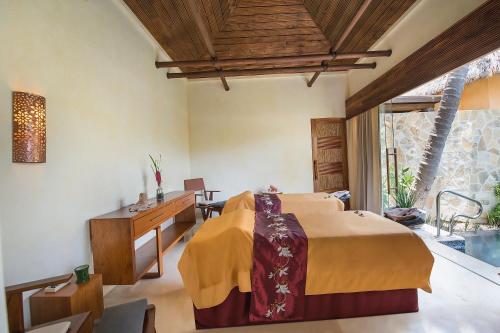 a bedroom with a bed and a desk in a room at Fiesta Americana Puerto Vallarta All Inclusive & Spa in Puerto Vallarta