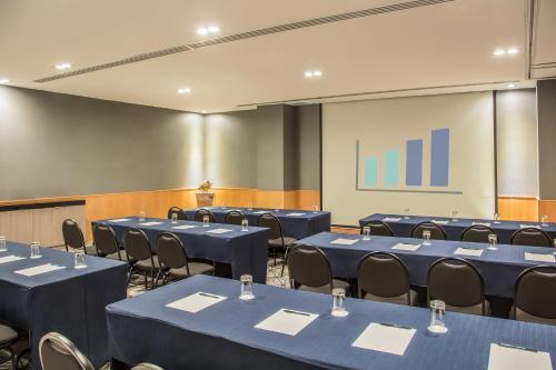 a conference room with blue tables and chairs at Fiesta Inn Puerto Vallarta Isla in Puerto Vallarta