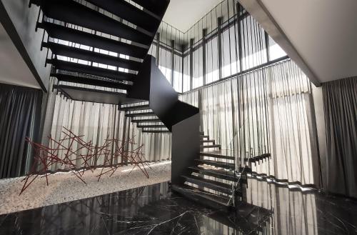 a spiral staircase in a building with windows at Fiesta Americana Monterrey Pabellón M. in Monterrey