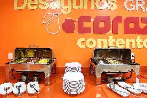 a restaurant with two trays of food and plates at One Cuernavaca in Cuernavaca