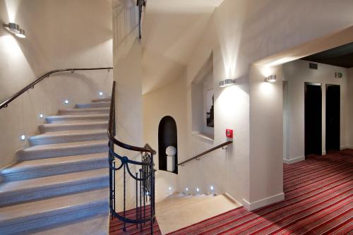 a staircase in a house with blue stairs at Red & Blue Design Hotel Prague in Prague