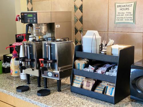 a kitchen counter with a coffee maker on a shelf at La Quinta Inn by Wyndham Tyler in Tyler
