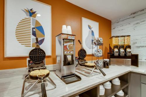 a room with a counter with two chairs and vases at Orangewood Inn and Suites Midtown in Austin