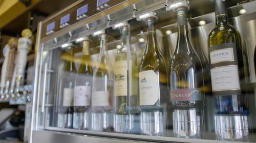 a bunch of bottles of wine on a shelf at The Nest Hotel Palo Alto in Palo Alto