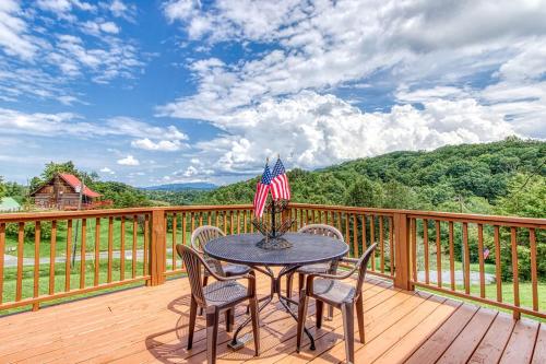 a table with chairs and an american flag on a deck at Amazing Grace-Cozy Cabin Retreat in the Smokies in Sevierville