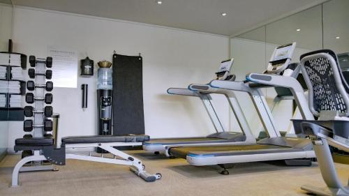 a gym with several tread machines in a room at The Nest Hotel Palo Alto in Palo Alto