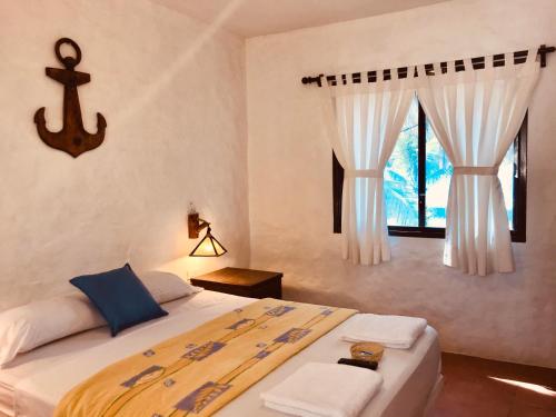 a bedroom with a large bed and a window at ALOHA LINA in Máncora