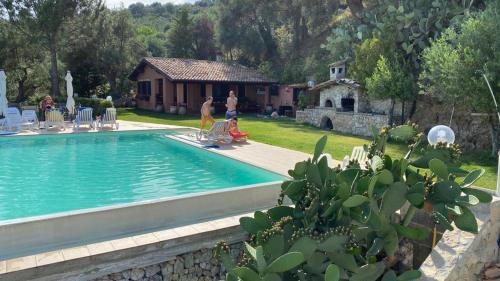 een zwembad in een tuin met een huis bij Villa Greco in Rossano