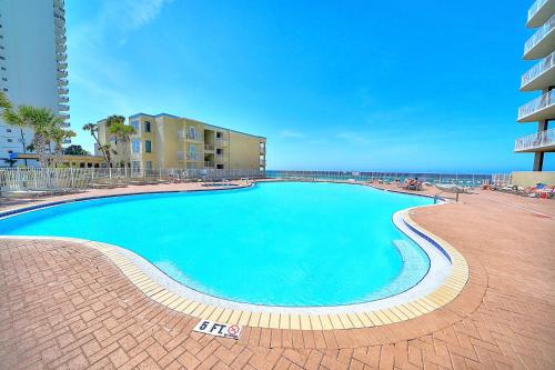 a large swimming pool next to a building at Amazing Sunset Oceanfront Condo in Panama City Beach