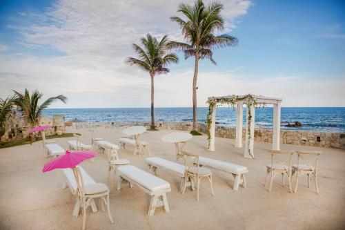 a wedding reception on the beach with palm trees at Grand Fiesta Americana Los Cabos All Inclusive Golf & Spa in Cabo San Lucas