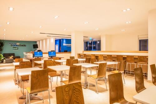 an empty cafeteria with tables and chairs at One Puebla Serdan in Puebla
