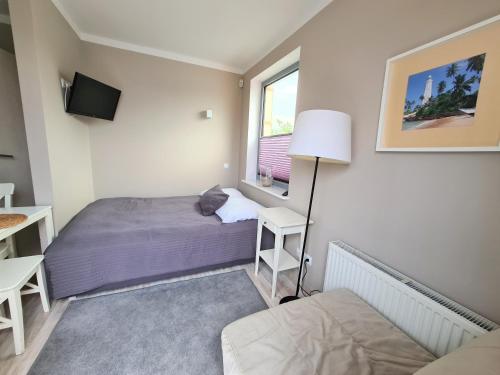 Posteľ alebo postele v izbe v ubytovaní Apartamenty Ekslibris