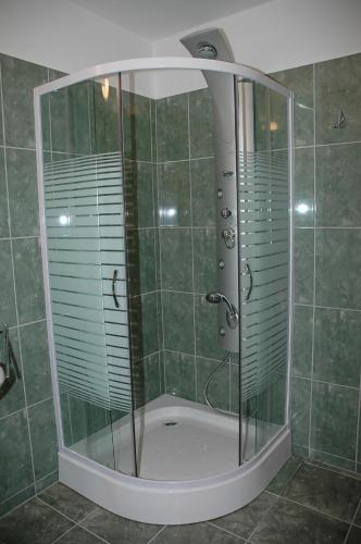 a shower with a glass enclosure in a bathroom at Marina Panzio in Siófok