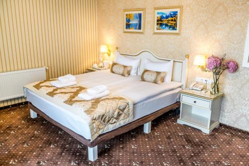 a bedroom with a large white bed with two night stands at FENIX TOWN in Vinnytsya