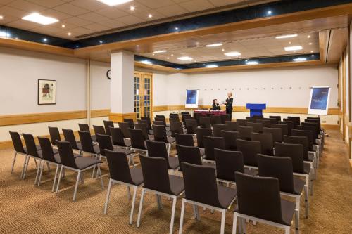 a conference room with chairs and a podium at Novotel Bristol Centre in Bristol