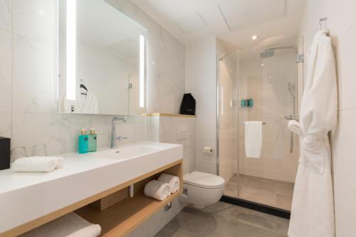 a bathroom with a toilet, sink, and bathtub at Crowne Plaza Utrecht - Central Station, an IHG Hotel in Utrecht