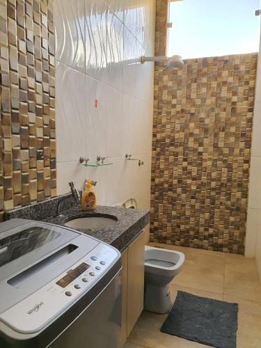 a small bathroom with a sink and a toilet at Tororoi Riberalta Apartments in Riberalta