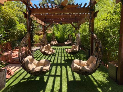 a patio area with chairs, tables and umbrellas at Lantern Light Inn - Romantic Getaway in Sedona