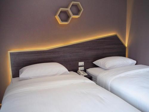 A bed or beds in a room at The Feeling Hotel