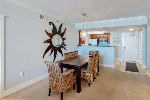 a dining room and kitchen with a table and chairs at Waterscape B603 in Fort Walton Beach