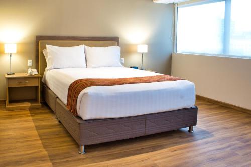 Ein Bett oder Betten in einem Zimmer der Unterkunft Estelar Apartamentos Bellavista