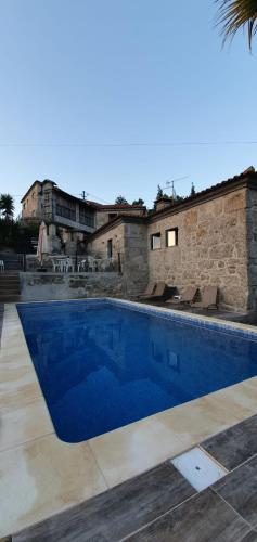 a swimming pool in front of a building at Villas da Quintã in Cabeceiras de Basto