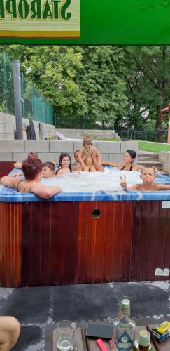 a group of people in a hot tub at Ubytovanie na súkromí KIKA in Santovka