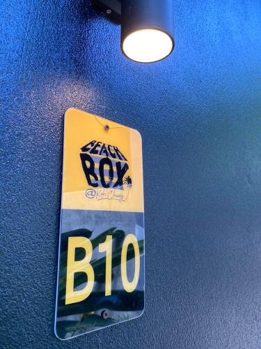 a sign hanging on a wall with a bmo sign at BeachBox@Koh Сhang in Ko Chang