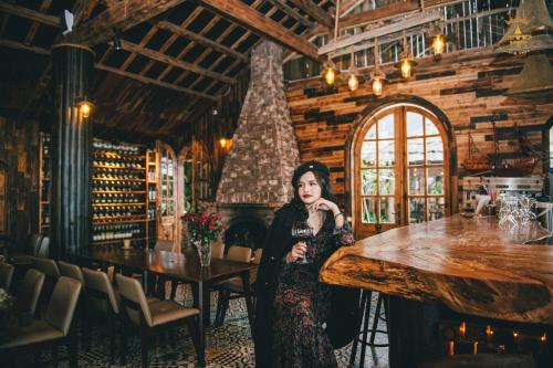 a woman standing in a room with a table at Chau Long Sapa 2 Hotel in Sa Pa